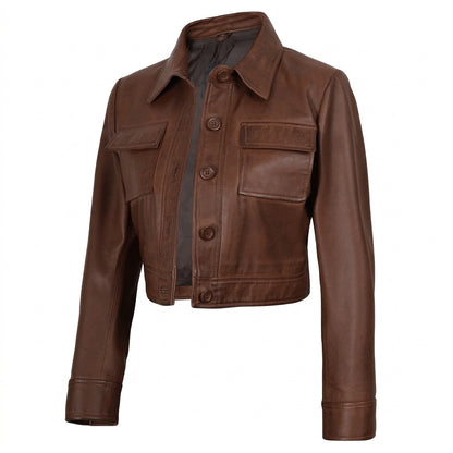 Women's cropped brown leather trucker jacket front view showing button-down closure and chest flap pockets.