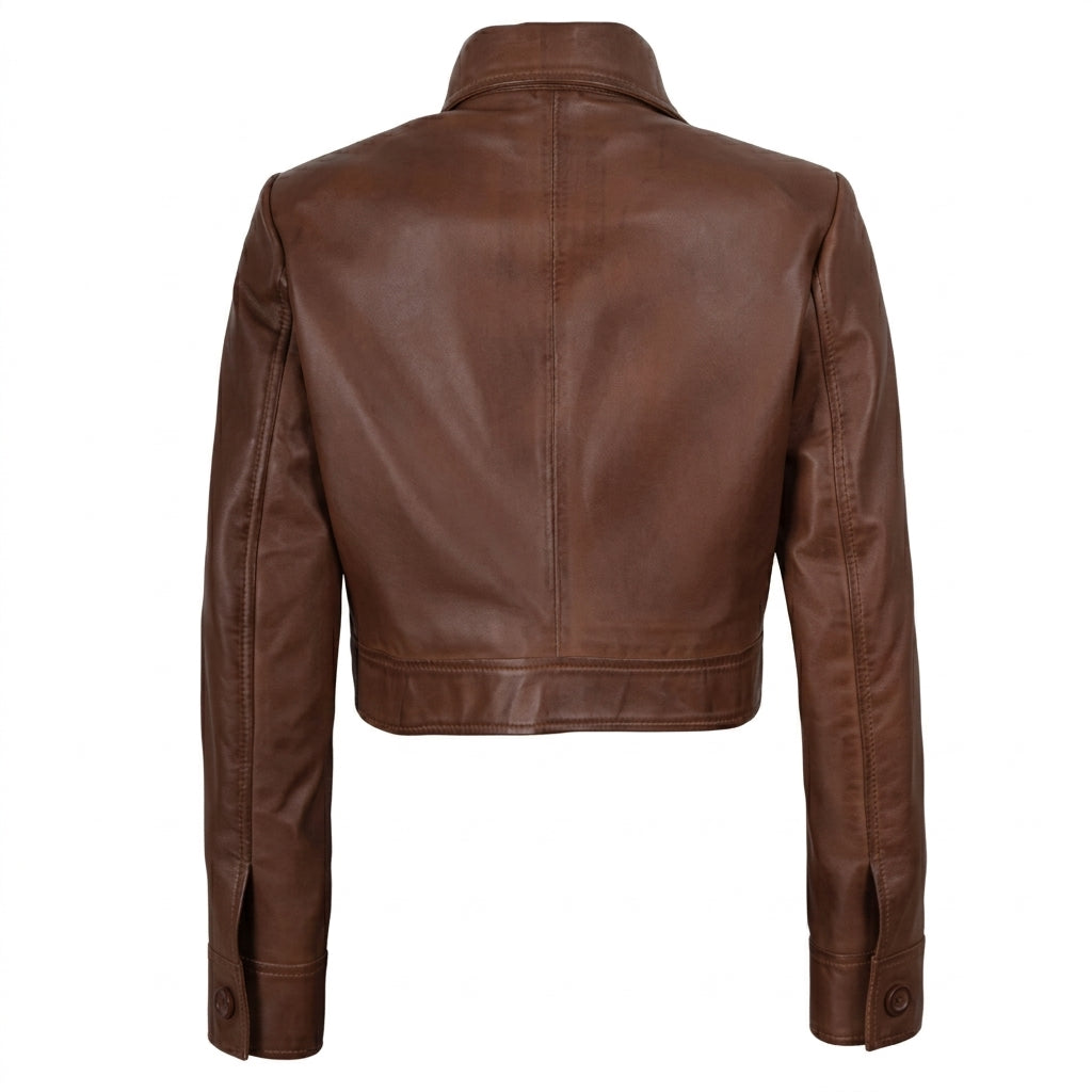 Women's cropped brown leather trucker jacket front view showing button-down closure and chest flap pockets.