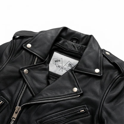 Imogen women's motorcycle leather jacket front view showing asymmetric zipper, waist belt, lapel snaps, and black leather finish.
