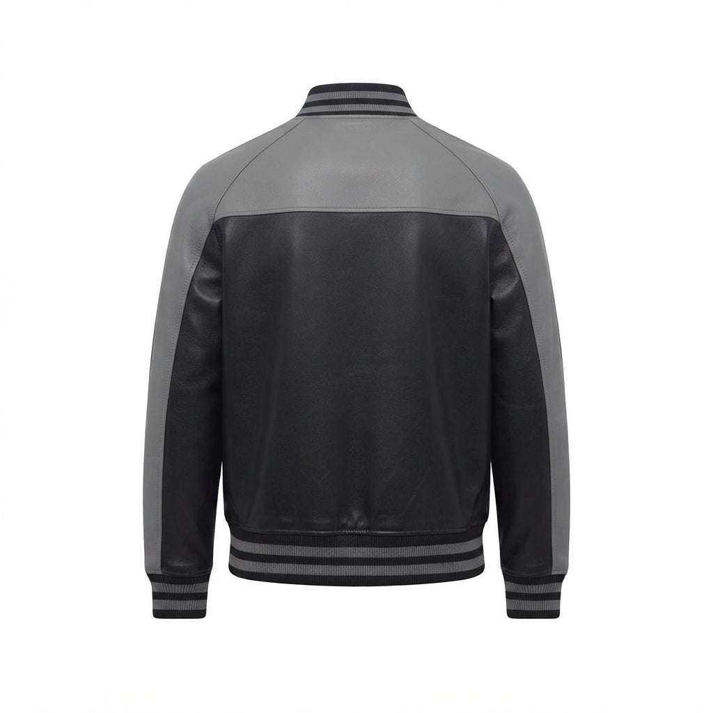 Men's Black and Grey Leather Varsity Jacket front view with contrast shoulders, snap-button placket, and striped ribbing, white background